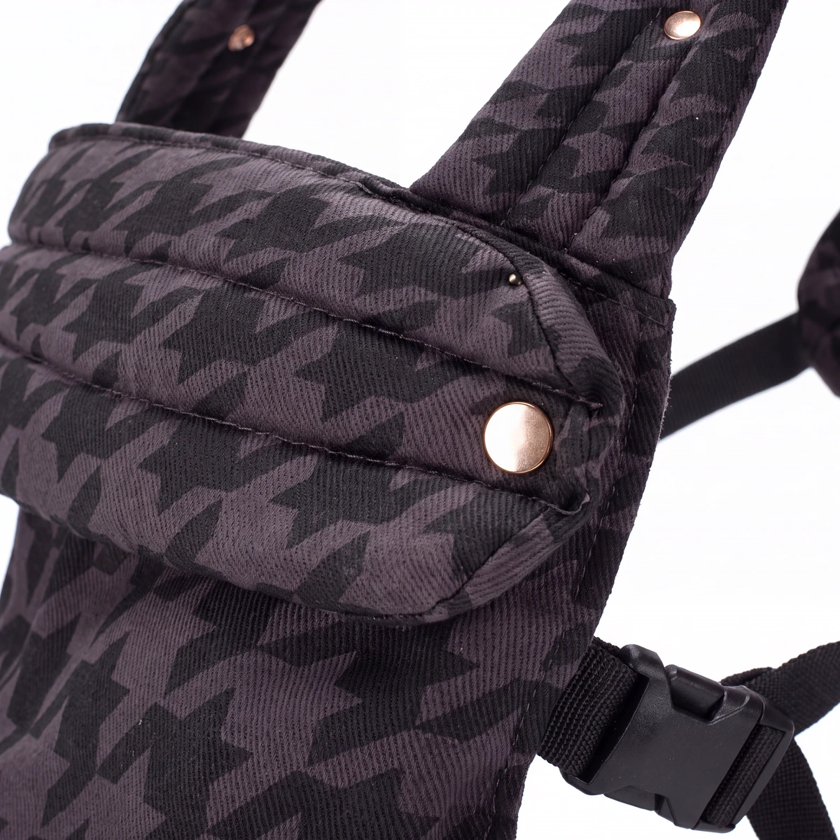 Close detail of a signature gold-tone snap, stitching and Onyx houndstooth cloth